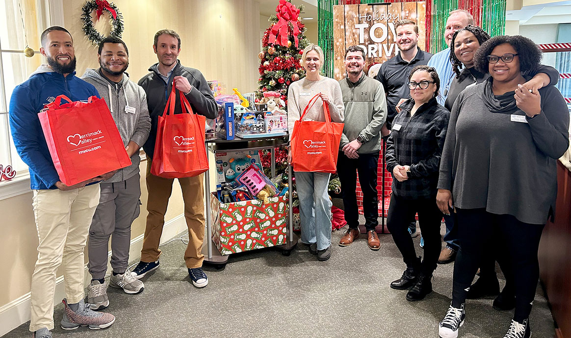 Brockton Boys & Girls Club staff join MVCU’s Bridgewater branch team members and showcase the generous toy donations made by the credit union community.