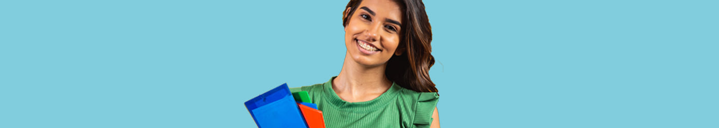 Female student holding books on a blue background