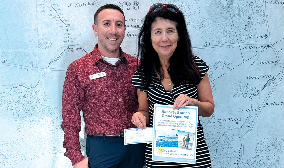 Hanover Branch Manager Marcello DiVincenzo smiles alongside Susan Morrison, the winner of the cruise giveaway.